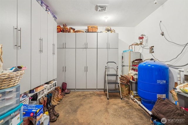 garage featuring water heater and visible vents