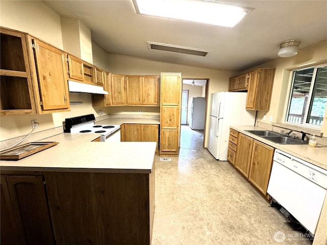 kitchen featuring a sink, white appliances, a peninsula, lofted ceiling, and under cabinet range hood
