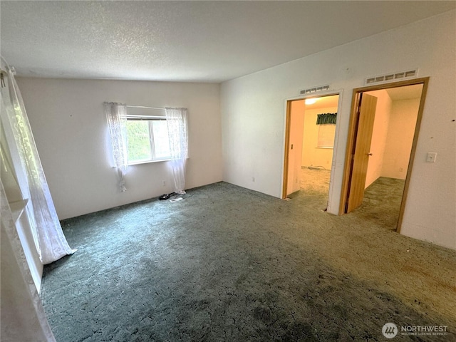 unfurnished bedroom featuring carpet floors and visible vents