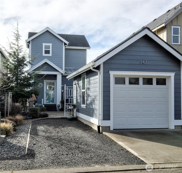 view of front of home with a garage, concrete driveway, and entry steps