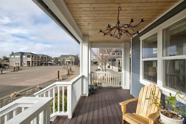 wooden terrace with covered porch and a residential view