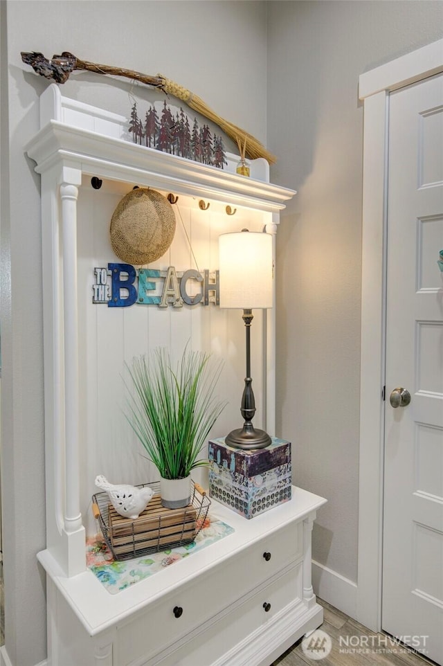 mudroom featuring light wood-style floors and baseboards