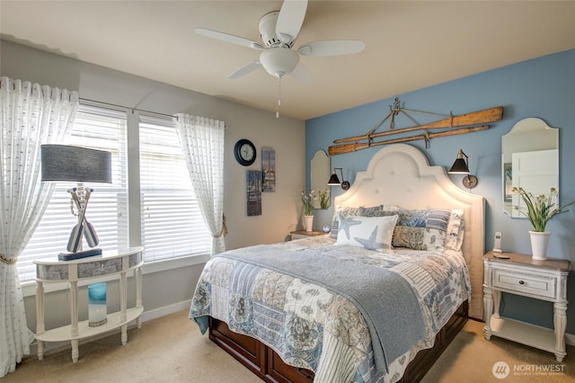 carpeted bedroom with ceiling fan, multiple windows, and baseboards