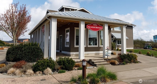 view of front of property with a standing seam roof and metal roof