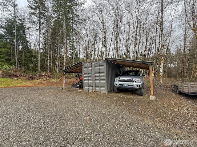 view of parking featuring a carport and driveway