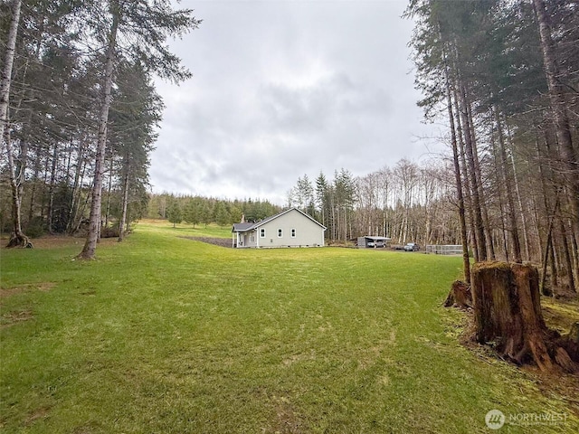 view of yard with a forest view