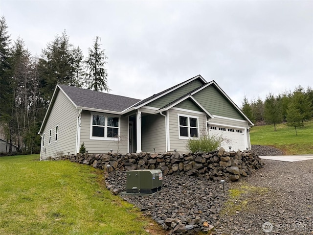 ranch-style home featuring an attached garage, a shingled roof, and a front lawn