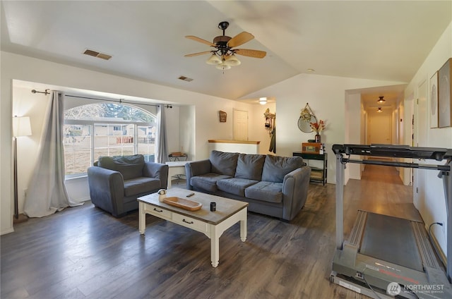 living room featuring a ceiling fan, dark wood finished floors, visible vents, and vaulted ceiling