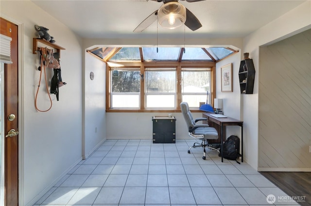 office space featuring light tile patterned floors, baseboards, and a ceiling fan