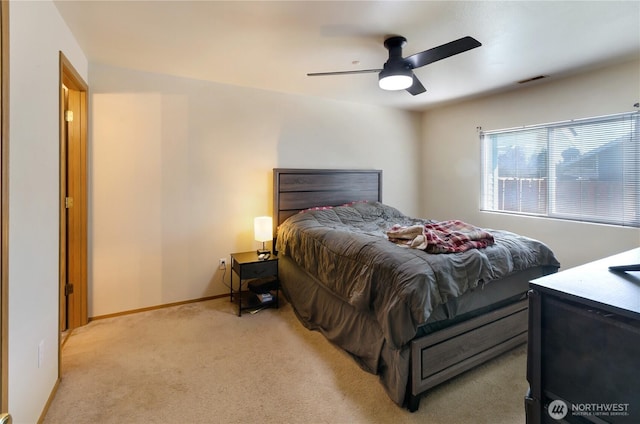 bedroom with baseboards, visible vents, ceiling fan, and light colored carpet