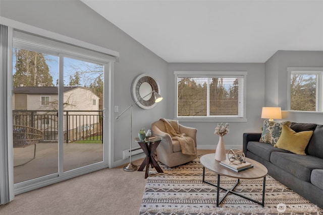 living room featuring lofted ceiling, carpet, a baseboard radiator, and baseboards