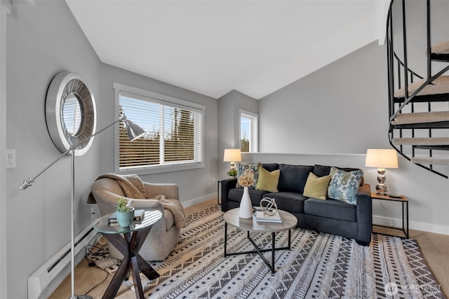 living area with lofted ceiling, stairway, baseboards, and baseboard heating