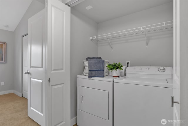 laundry room with laundry area, baseboards, light colored carpet, and washing machine and clothes dryer