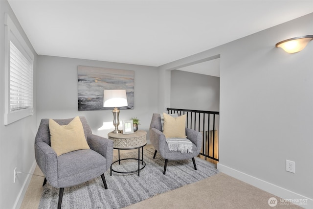 sitting room featuring carpet and baseboards