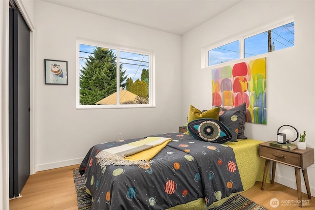 bedroom featuring baseboards and wood finished floors