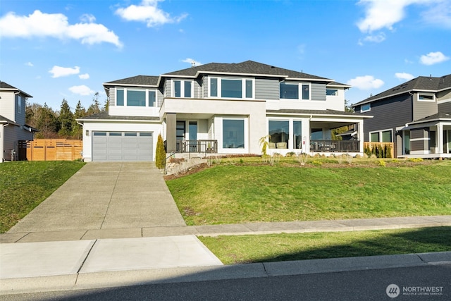 view of front facade with driveway, a garage, covered porch, fence, and a front yard