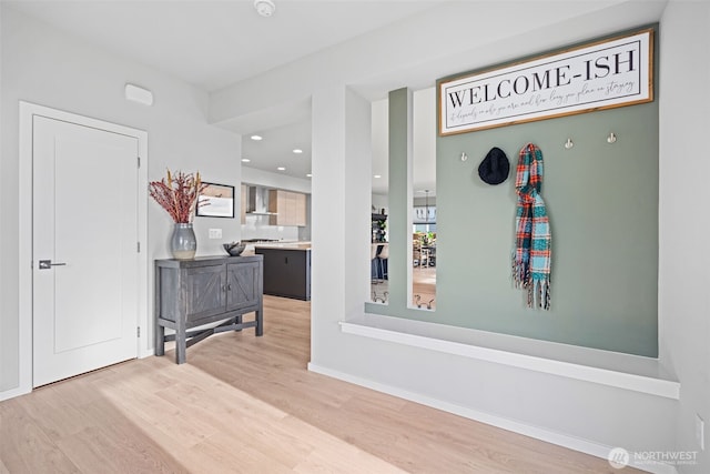 entryway featuring recessed lighting, baseboards, and wood finished floors