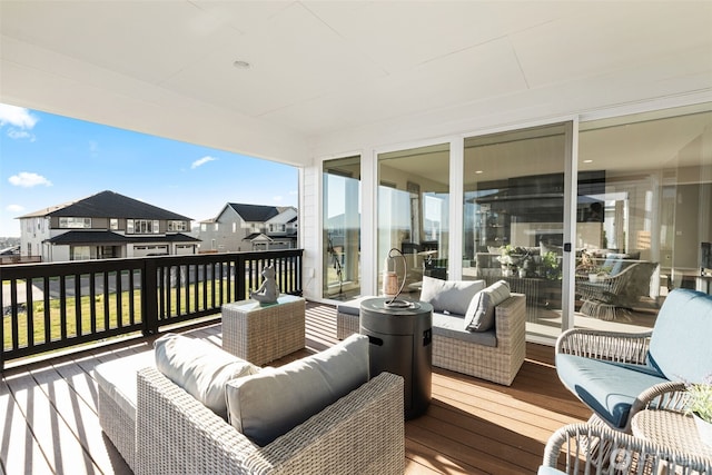 wooden deck featuring a residential view and an outdoor hangout area