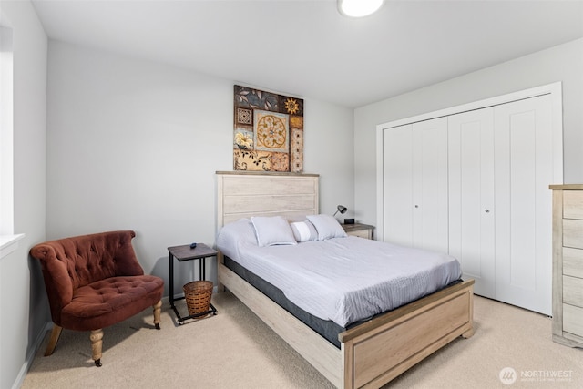 bedroom featuring a closet and light colored carpet