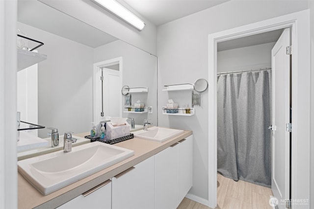 full bath featuring double vanity, a sink, and a shower with shower curtain