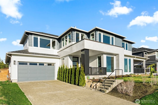 view of front of property featuring a garage, covered porch, and driveway