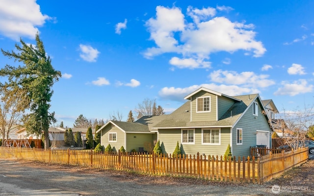 view of front of home with a garage and a fenced front yard