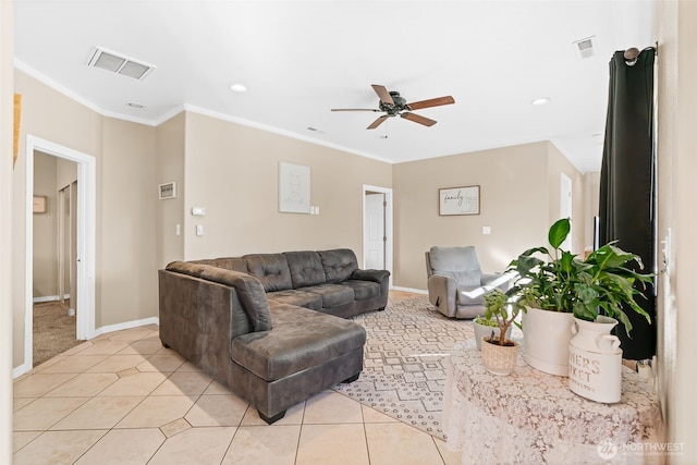 living area with light tile patterned floors, visible vents, baseboards, ceiling fan, and crown molding