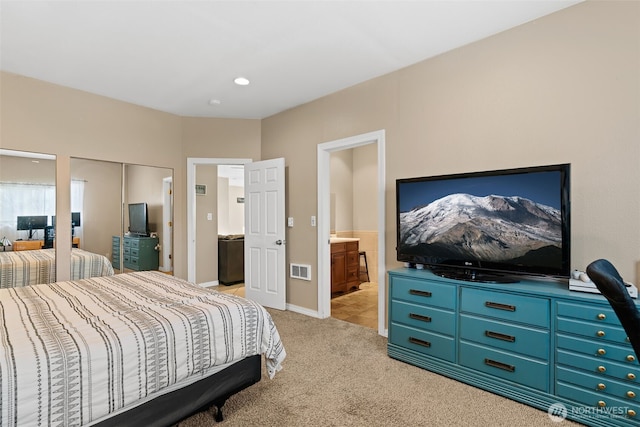 bedroom with light carpet, connected bathroom, visible vents, and baseboards