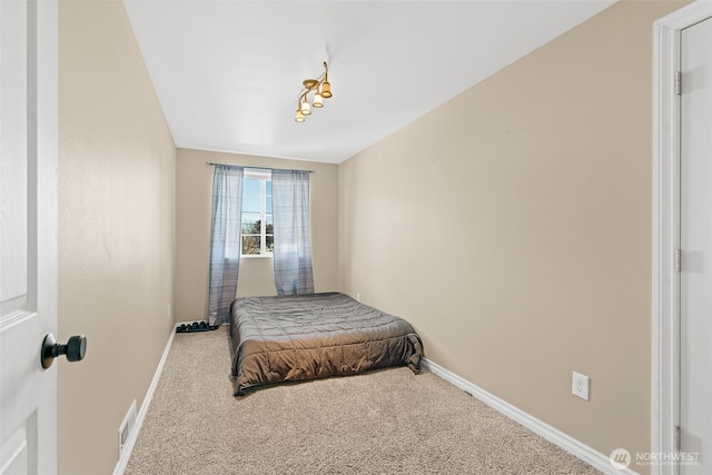 bedroom featuring carpet flooring, visible vents, and baseboards