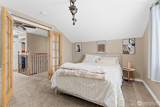 bedroom featuring vaulted ceiling, carpet, and baseboards