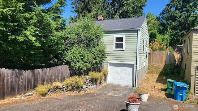 14934 5th Ave NE, Shoreline, WA 98155 - view of front of house with a chimney, an outdoor structure, an attached garage, fence, and aphalt driveway