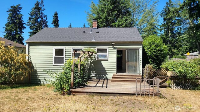 14934 5th Ave NE, Shoreline, WA 98155 - rear view of property featuring roof with shingles, a chimney, fence, entry steps, and a lawn