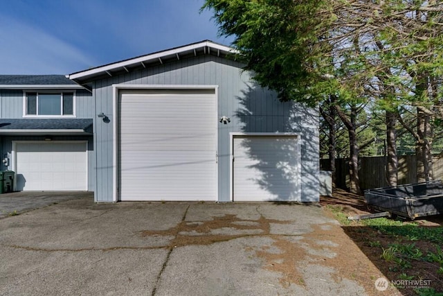 detached garage featuring fence