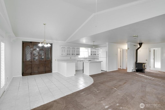 kitchen with light carpet, white appliances, glass insert cabinets, a center island, and an inviting chandelier