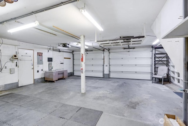 garage featuring a garage door opener and electric panel