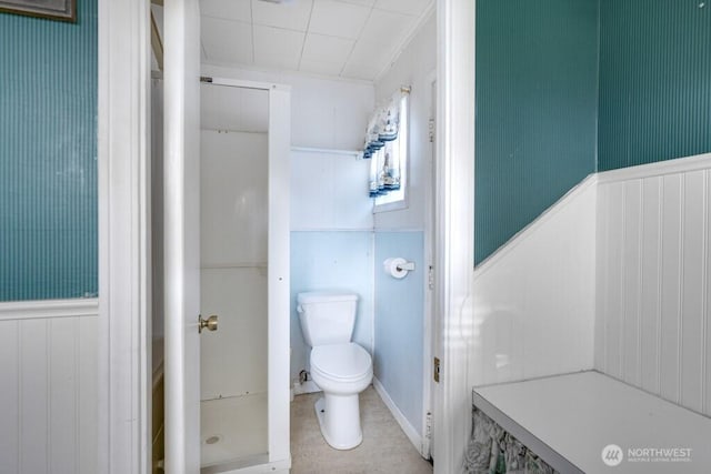 bathroom featuring wainscoting and toilet