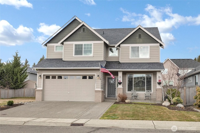 craftsman-style home with an attached garage, driveway, fence, and brick siding