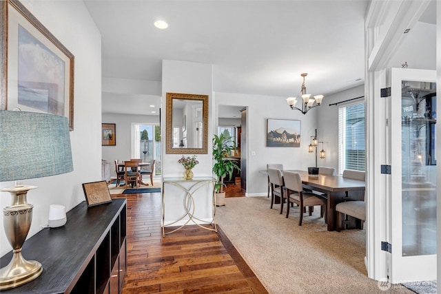 interior space with an inviting chandelier, dark wood-type flooring, a wealth of natural light, and recessed lighting