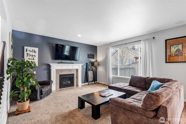 carpeted living room with recessed lighting, a tiled fireplace, and baseboards