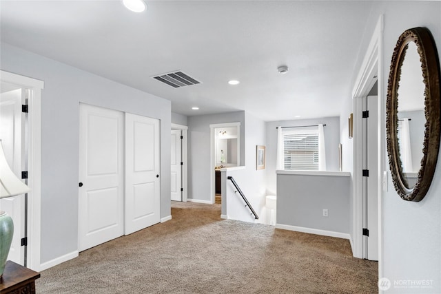 interior space with carpet, visible vents, baseboards, and recessed lighting