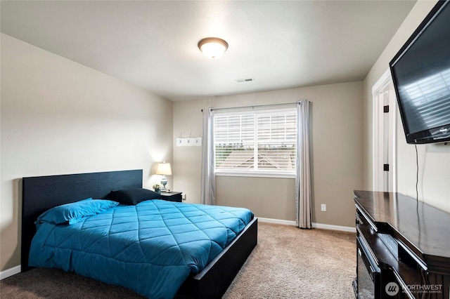 carpeted bedroom with baseboards and visible vents