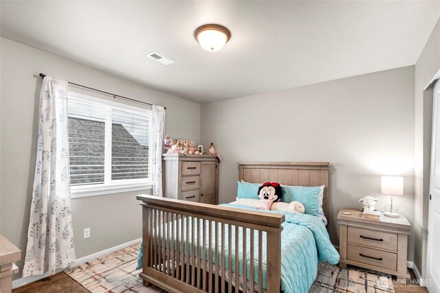 bedroom featuring visible vents and baseboards