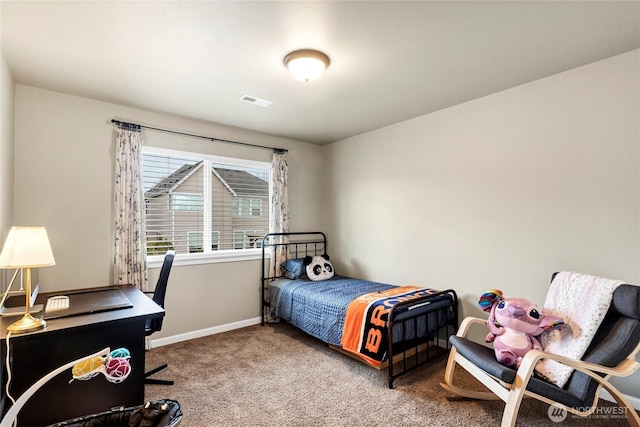 carpeted bedroom with visible vents and baseboards