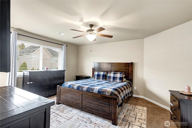 bedroom featuring baseboards, ceiling fan, and light colored carpet