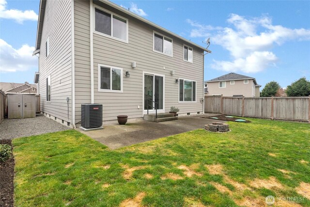 back of property featuring a lawn, a patio area, cooling unit, and a fenced backyard