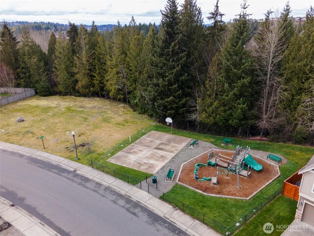 drone / aerial view featuring a view of trees