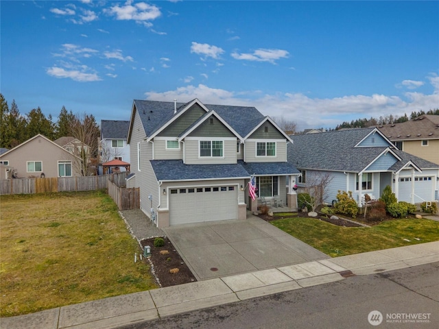 view of front of home with a garage, a residential view, fence, and a front lawn