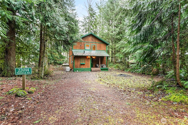 rustic home featuring covered porch