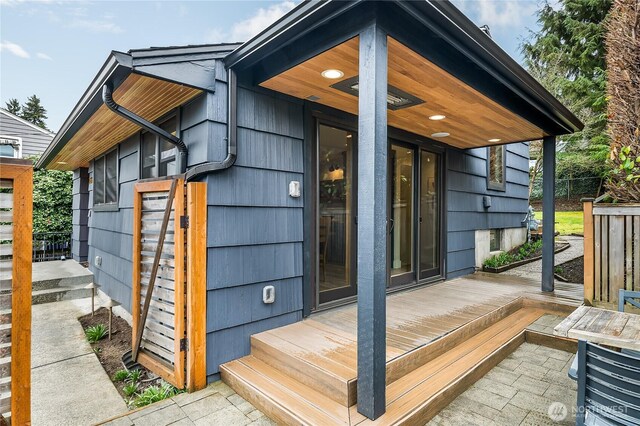 view of exterior entry featuring a wooden deck