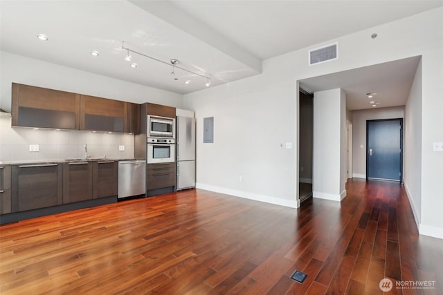 kitchen with stainless steel appliances, wood finished floors, visible vents, and modern cabinets